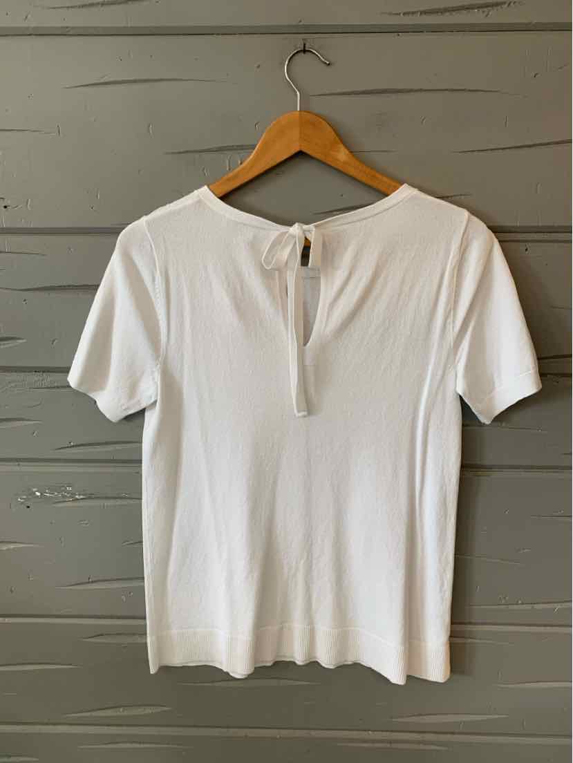 White short-sleeve knit top with a round neckline and back keyhole button closure, size small.
