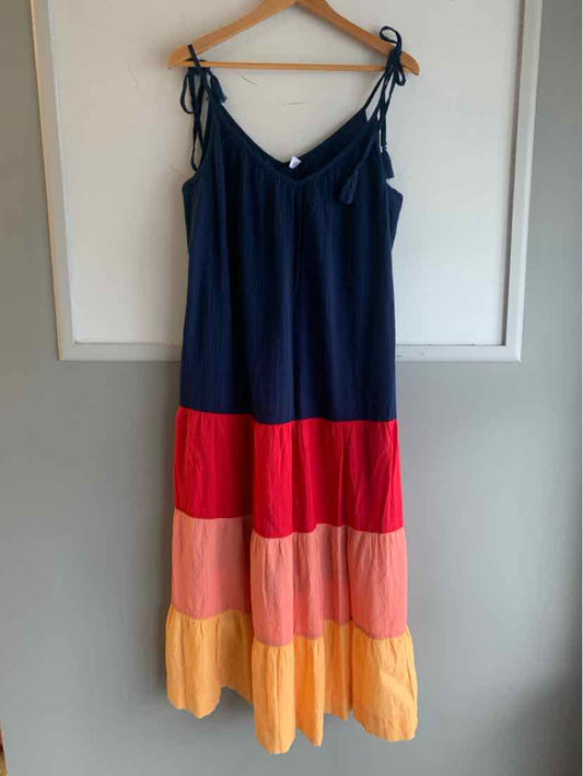 Navy blue sleeveless dress with adjustable tie straps and color block tiers in red, pink, and yellow.