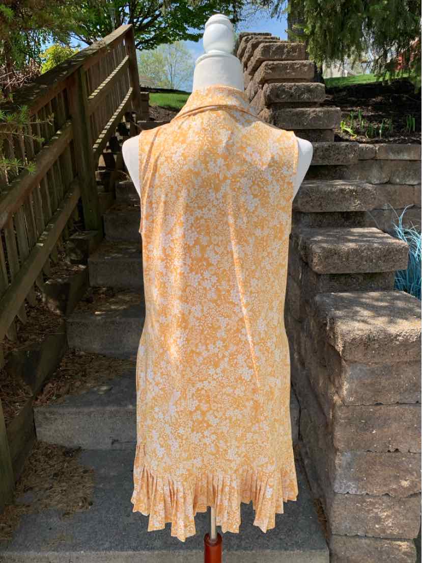 Sleeveless yellow floral dress with ruffled hem, collared neckline, and loose fit.