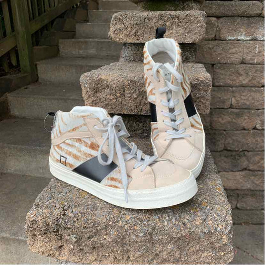 Beige high-top sneakers with white soles, zebra print accents, black side panel, and white laces.