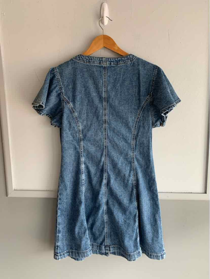 Medium blue denim short-sleeve dress with fitted waist and flared skirt hanging on wooden hanger.
