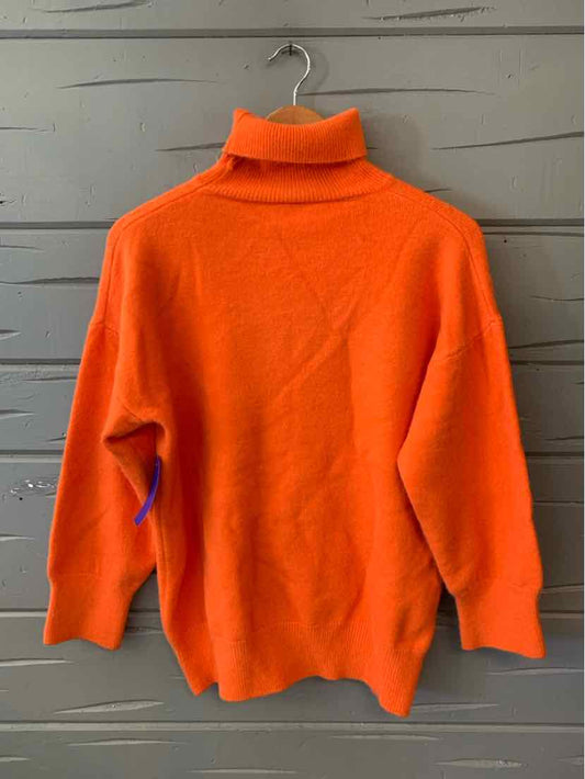 Bright orange women's casual top with turtleneck and long sleeves, perfect for layering with denim jeans or stylish boots.