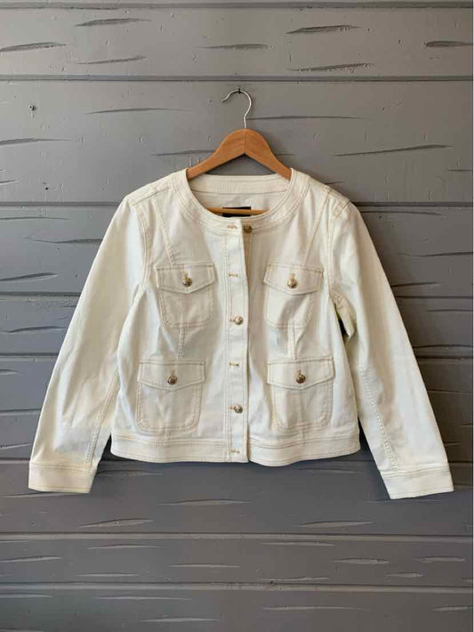 White long-sleeve button-up denim jacket with chest pockets and a fitted waist on a wooden hanger.