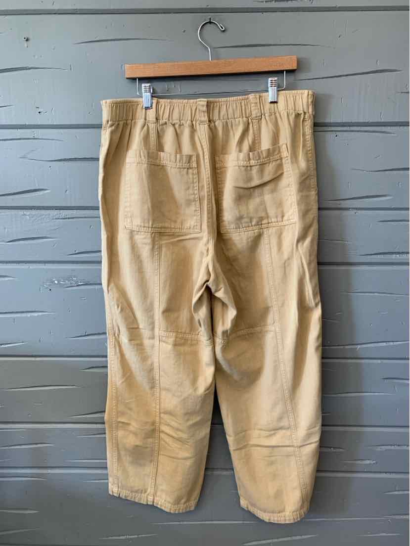 Tan cropped straight-leg pants with an elastic waistband, belt loops, and large patch pockets.