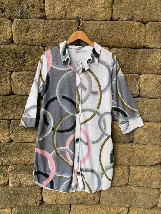 Long button-up shirt with multicolor abstract circle pattern, three-quarter sleeves, collar, and side slits.