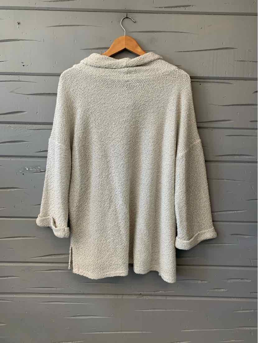 Beige plush fleece pullover with a soft cowl neck, long sleeves, and a relaxed tunic-length fit.
