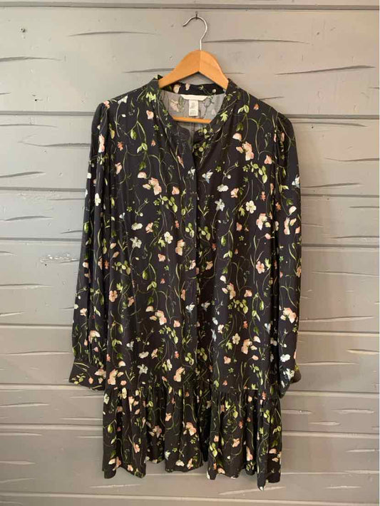 Black long-sleeve floral dress with green, white, and pink flower patterns, button-down front, pleated hem, size XL.