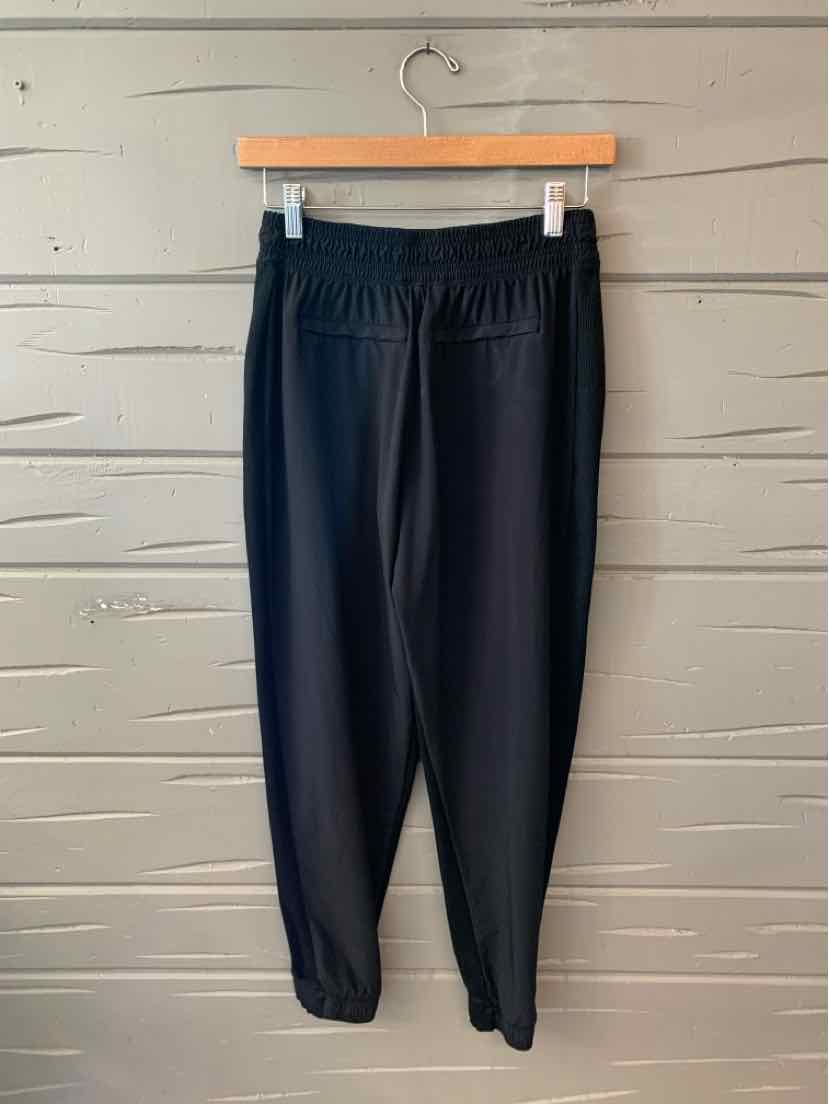 Black tapered athletic joggers with elastic waistband and cuffs, lightweight fabric.