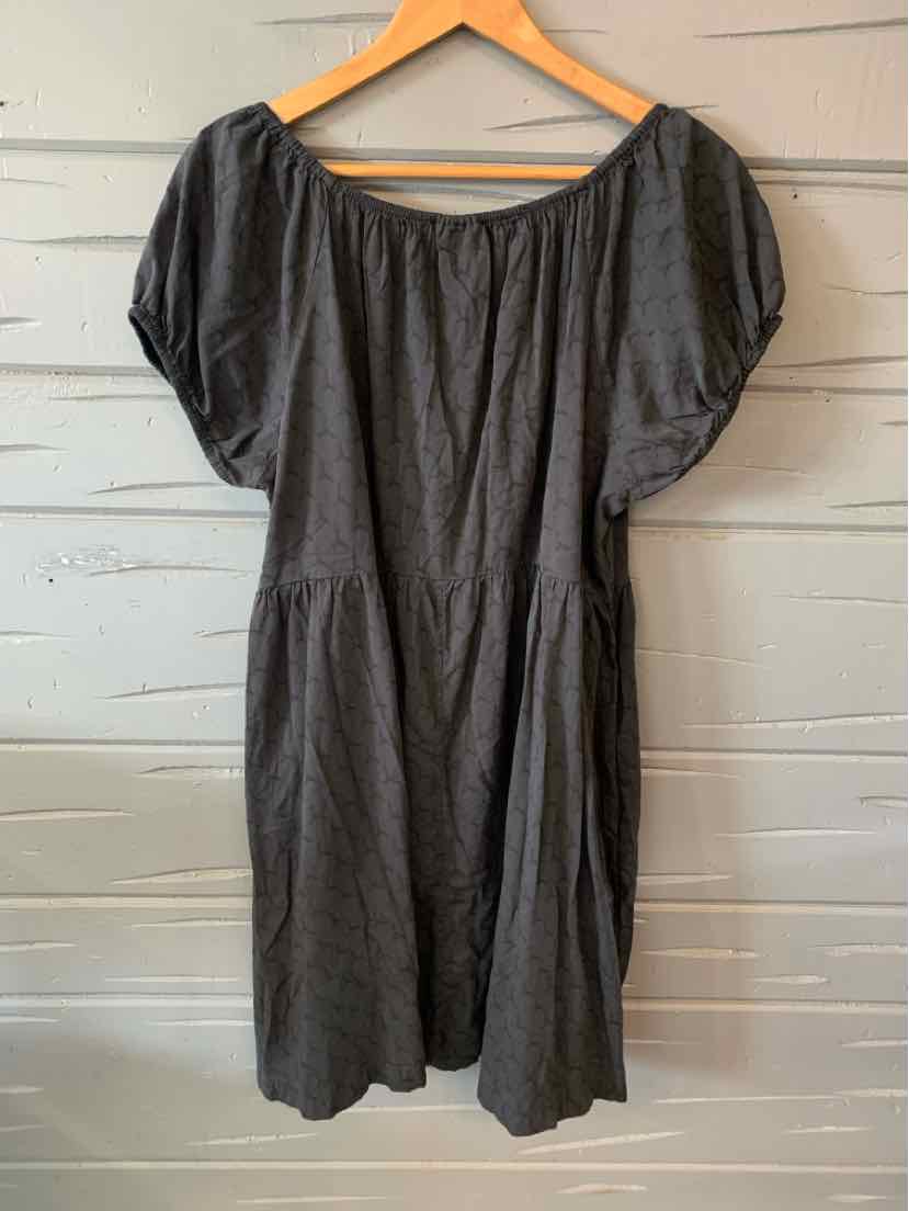 Dark gray short-sleeve dress with gathered neckline and loose fit hanging on wooden hanger.