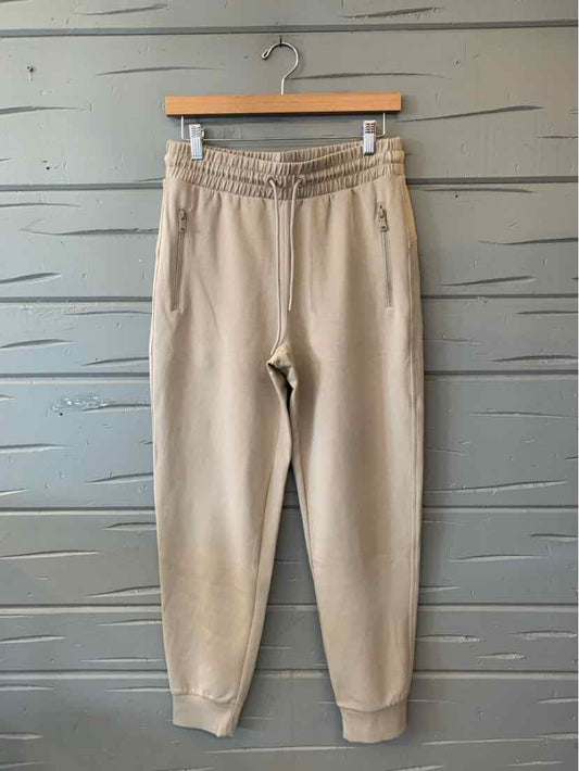Beige Old Navy jogger pants with an elastic drawstring waist, tapered legs, and ribbed cuffs.
