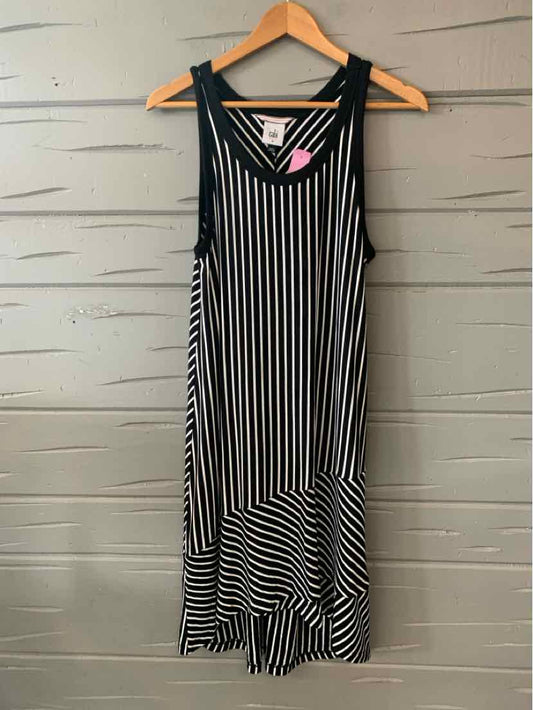 Black and white vertical striped sleeveless mid-length dress with V-neck on wooden hanger.