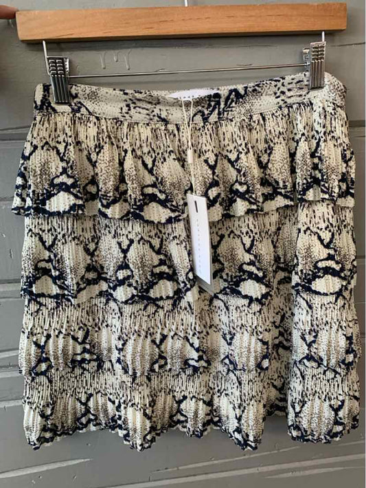 White and black snake print mini skirt with tiered ruffle layers and elastic waistband.