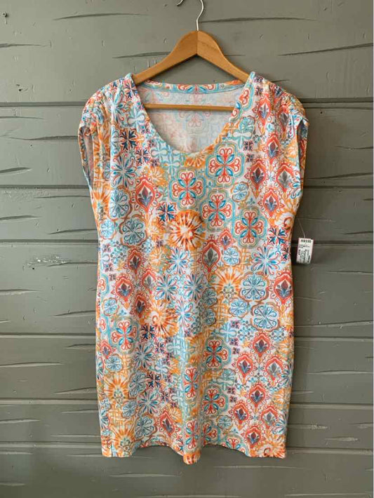 Short-sleeve V-neck top with orange, blue, and white geometric pattern on lightweight fabric.