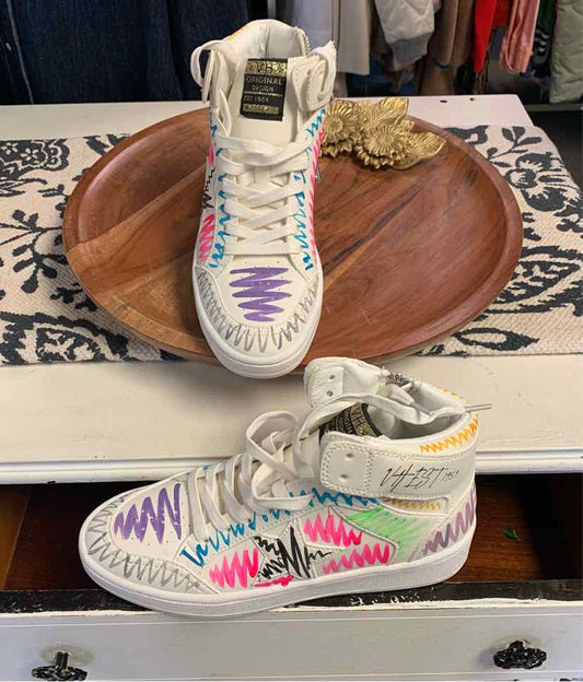 White sneaker with multicolor zigzag stitching and Velcro ankle strap in size 8.5.
