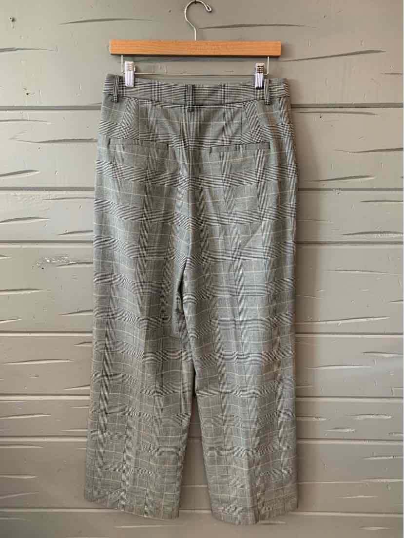Gray plaid straight-leg pants with belt loops and back welt pockets, size 6, hanging on wooden hanger.