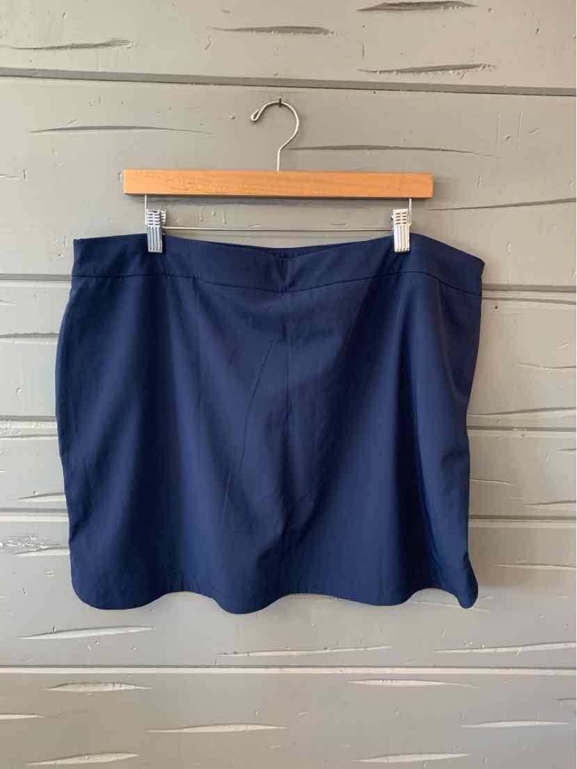 Navy blue solid skort with slight A-line shape hanging on wooden hanger.