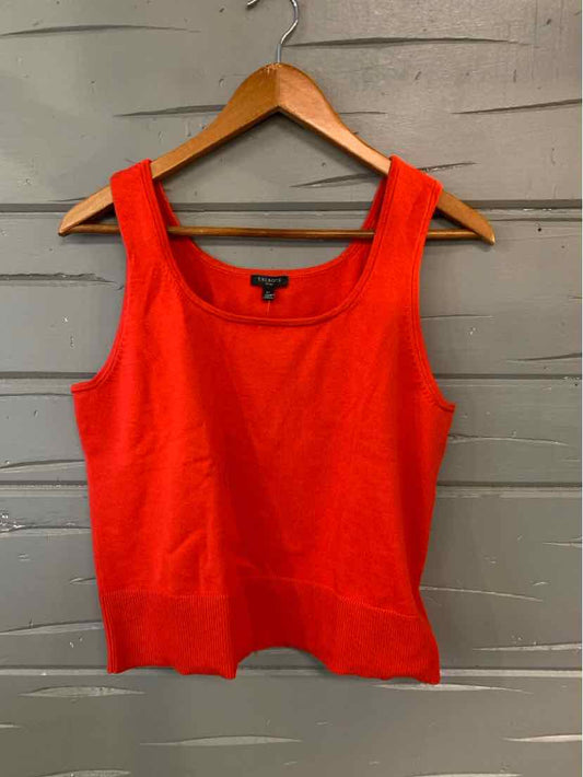 Bright red sleeveless knit tank top with scoop neckline on wooden hanger.