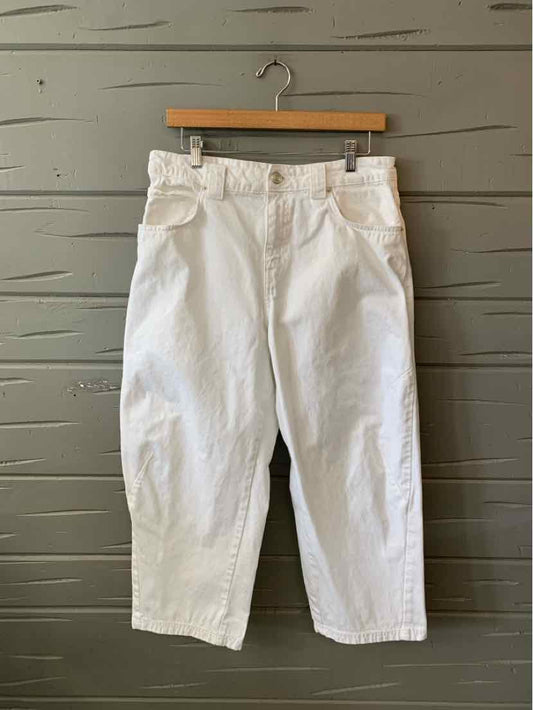 High-waist white denim pants with belt loops and front pockets, size 8, hanging on wooden hanger.