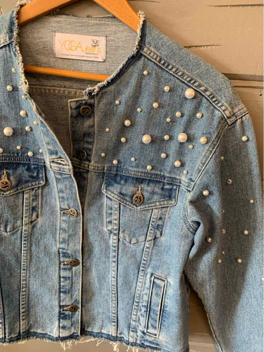 Light blue denim jacket with pearl embellishments scattered across front and sleeves, button-front closure, and flap chest.