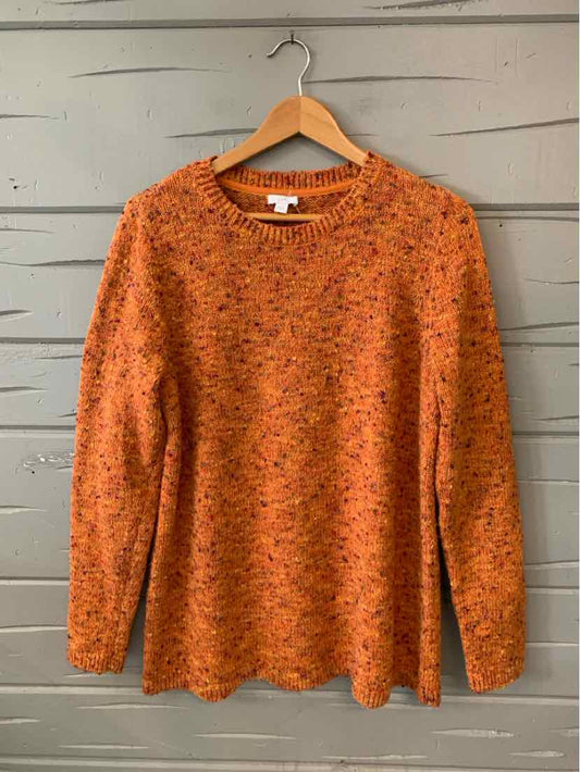 Orange knit long-sleeve sweater with multicolor speckles and a crew neckline on wooden hanger.
