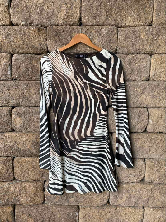 Long-sleeve mini dress with black and white zebra print, fitted silhouette, lightweight fabric.
