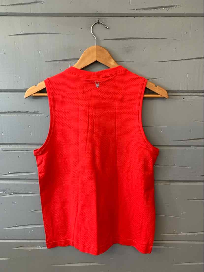 Bright red sleeveless athletic top with a round neckline and relaxed fit, hanging on a wooden hanger.