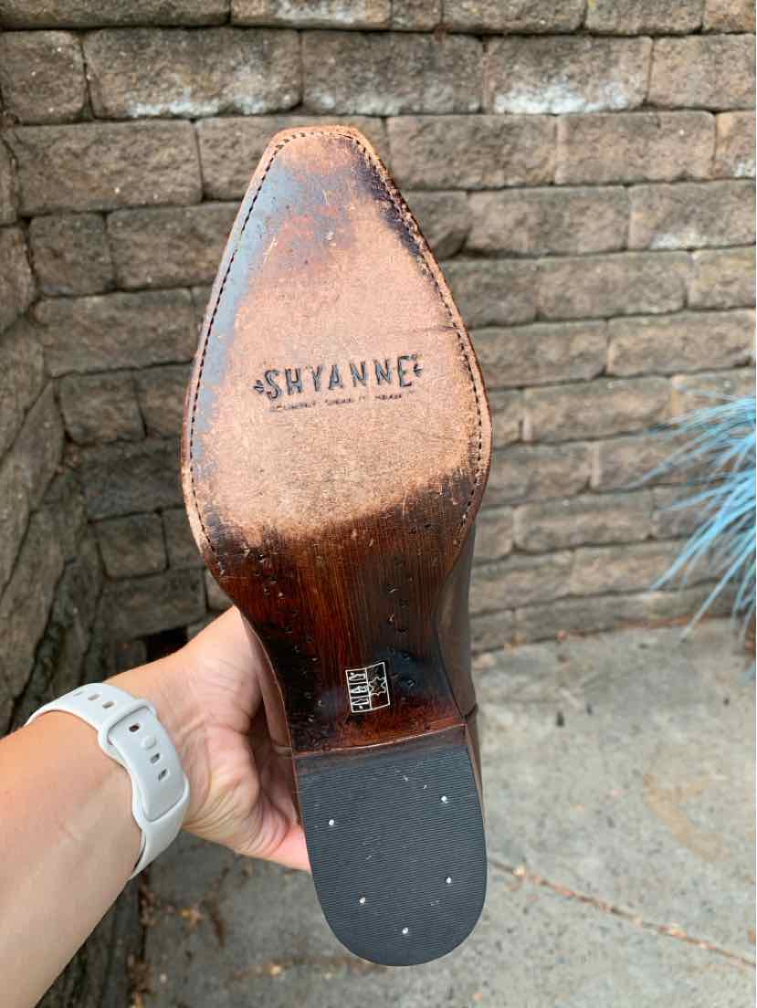 Brown leather western boot sole with SHYANNE brand stamped, black rubber heel cap, and worn finish.