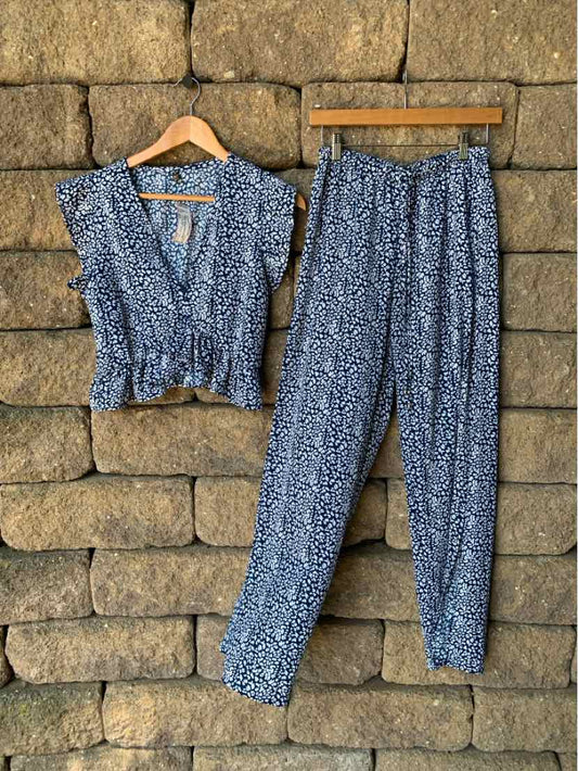 Blue floral short-sleeve blouse with a V-neck paired with matching blue floral loose pants.