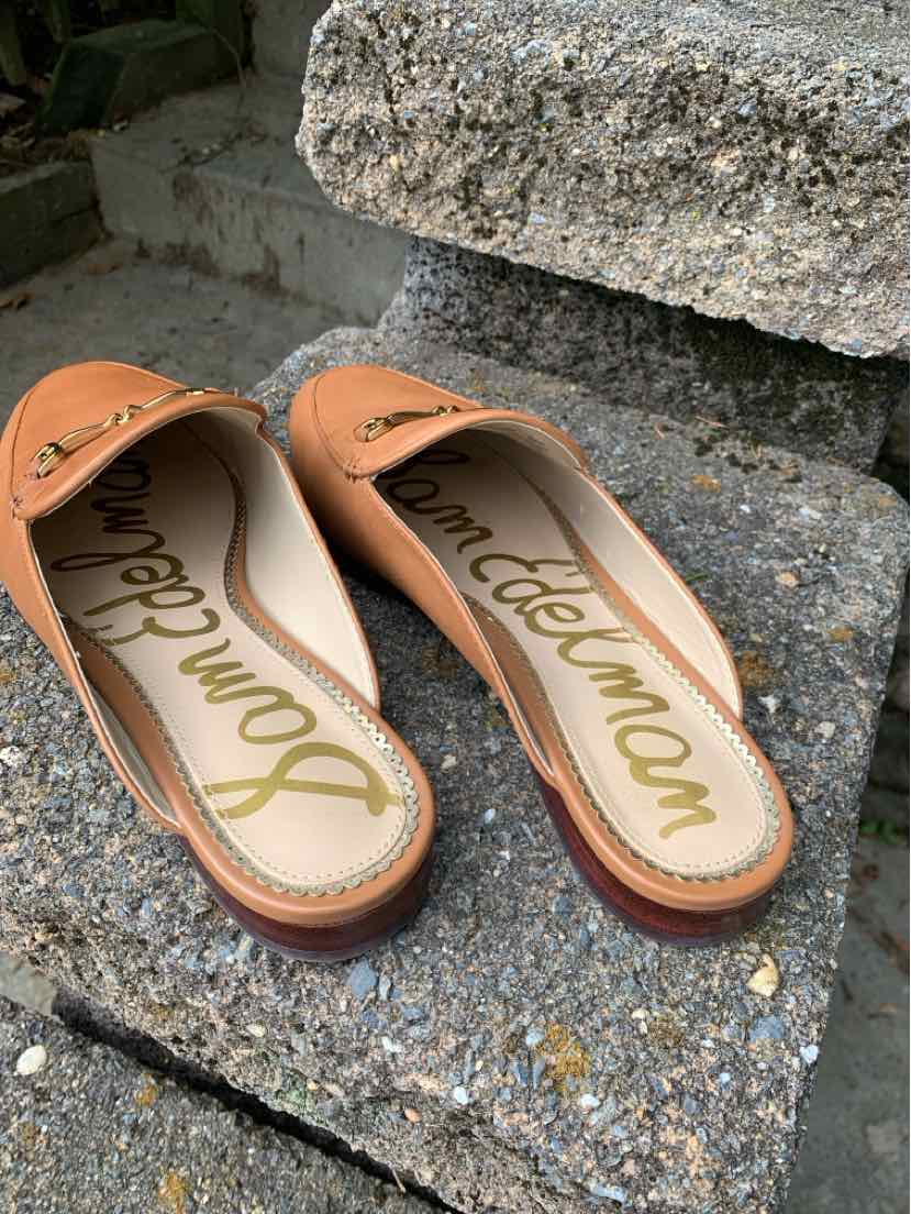 Tan Sam Edelman ballet flats with rounded toes, brown trim, and gold script insoles.