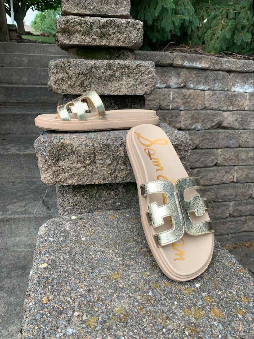 Metallic gold slide sandal with wide double strap and cushioned beige sole, size 8.