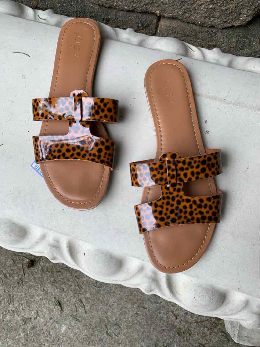 Tan sandal with two wide cheetah-print straps and cushioned sole, size 9.
