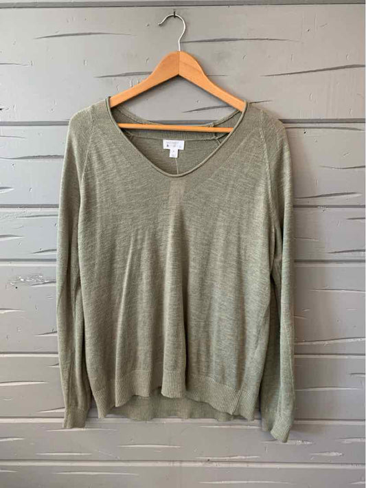 Light green V-neck long-sleeve sweater with a relaxed fit on wooden hanger.