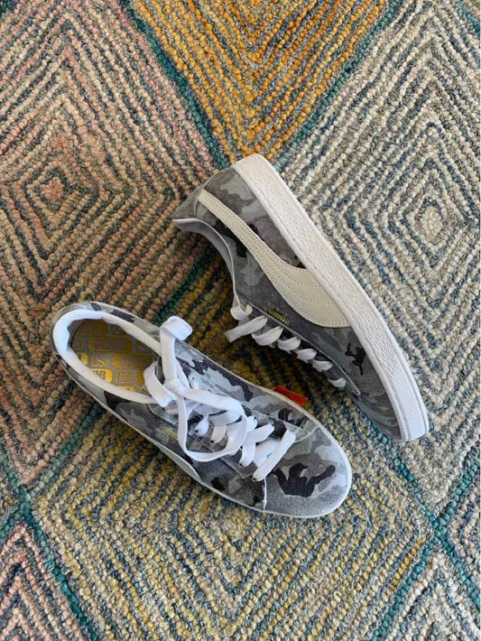 Gray and white camouflage low-top sneakers with white soles and laces, size 10.5.