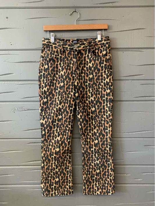 Tan leopard print cropped pants with a tied waist belt and straight legs.