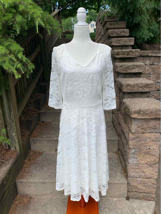 White lace dress with three-quarter sleeves, scoop neckline, and flared skirt in XL size.