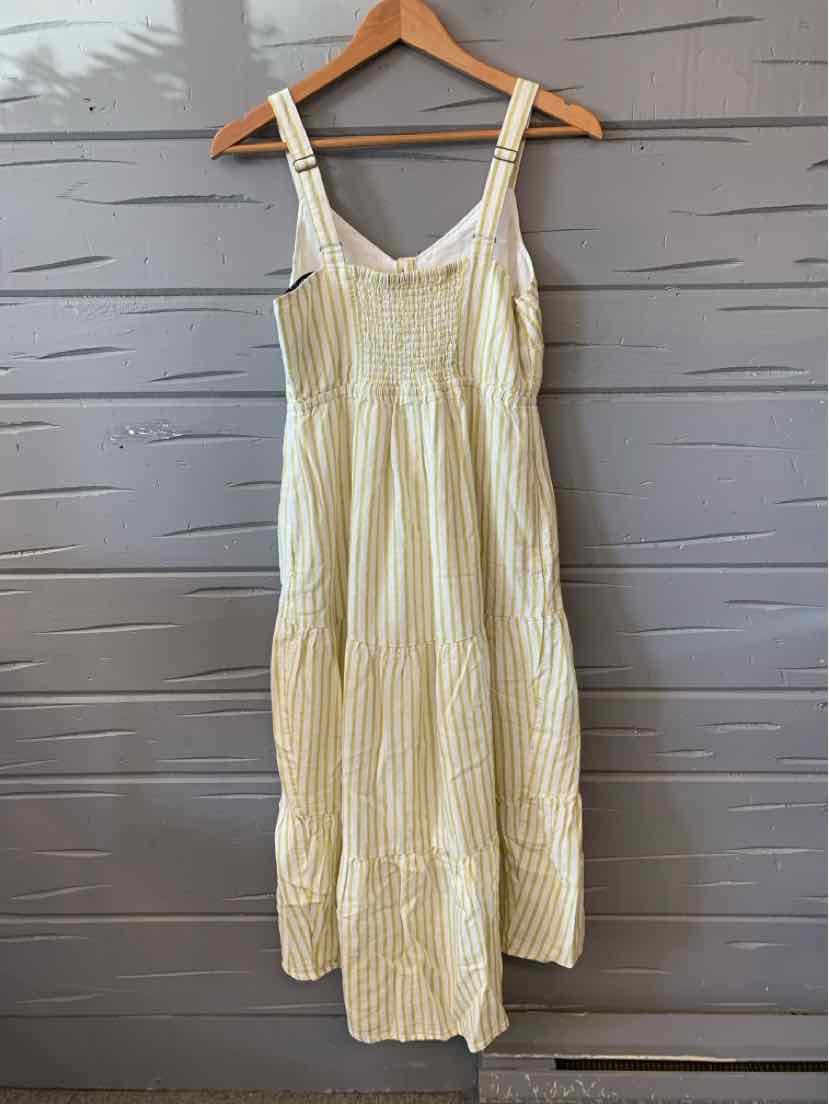 Light green and white striped sleeveless midi dress with adjustable straps and gathered waistline.