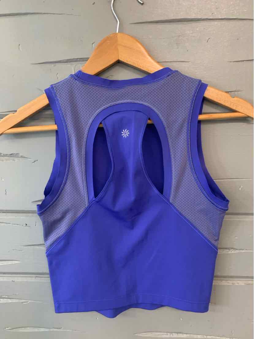 Blue sleeveless athletic crop top with racerback and keyhole detail at back.