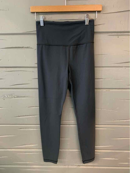 Dark gray high-waist cropped leggings with wide waistband and smooth finish.