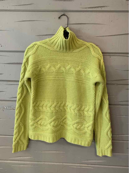 Pale yellow-green cashmere sweater with a ribbed turtleneck, textured knit patterns, and long sleeves.