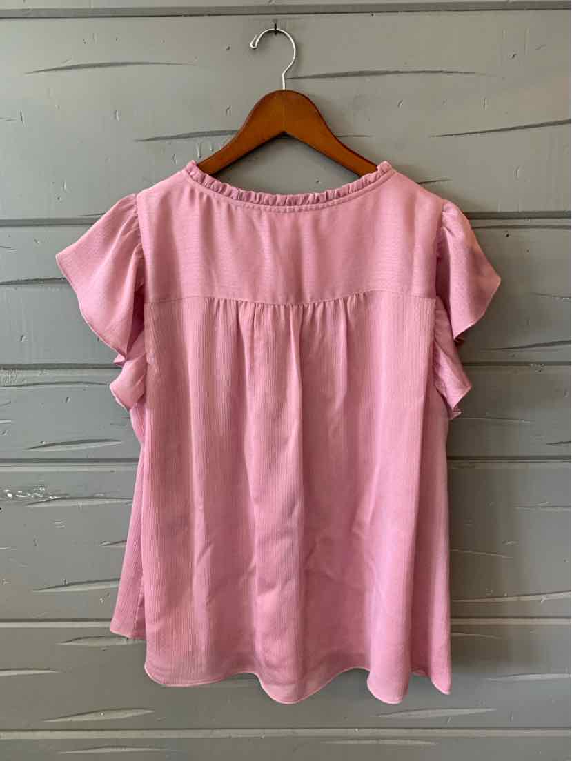 Light pink short-sleeve blouse with ruffle details and gathered yoke on back, size large.