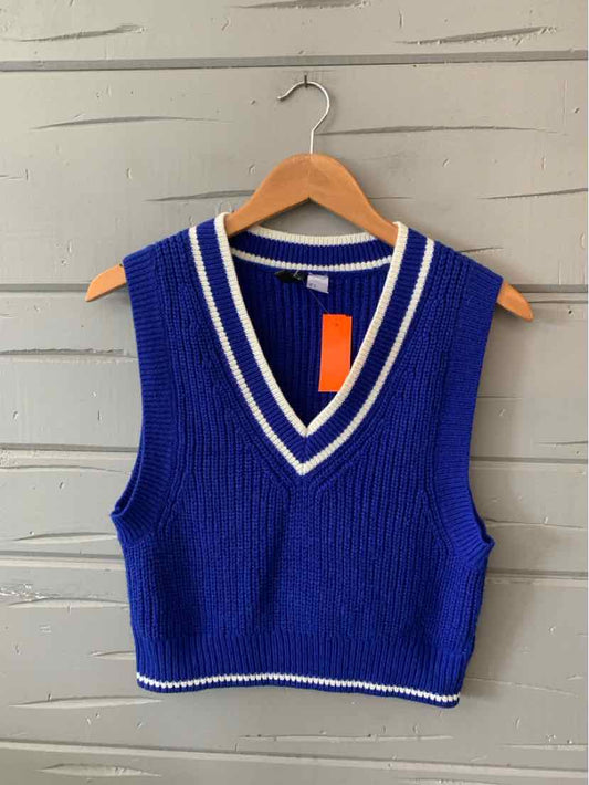 Cobalt blue knit sleeveless sweater vest with white striped V-neck and hem.