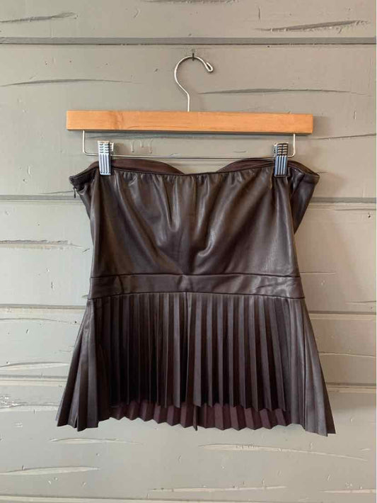 Brown faux leather mini skirt with pleated hem and gathered waist on wooden hanger.