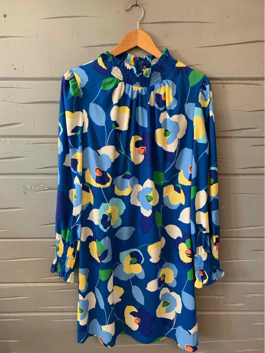 Blue floral long-sleeve dress with high neckline and loose fit on wooden hanger.