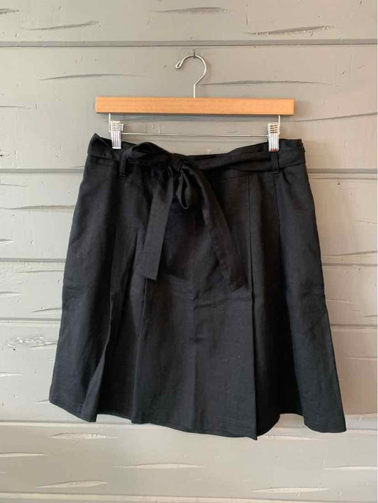 Black knee-length skirt with front tie belt and slight A-line shape, size 12.