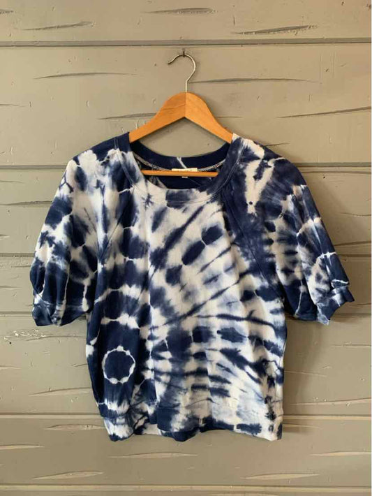 Navy and white tie-dye short-sleeve t-shirt with relaxed fit on wooden hanger.
