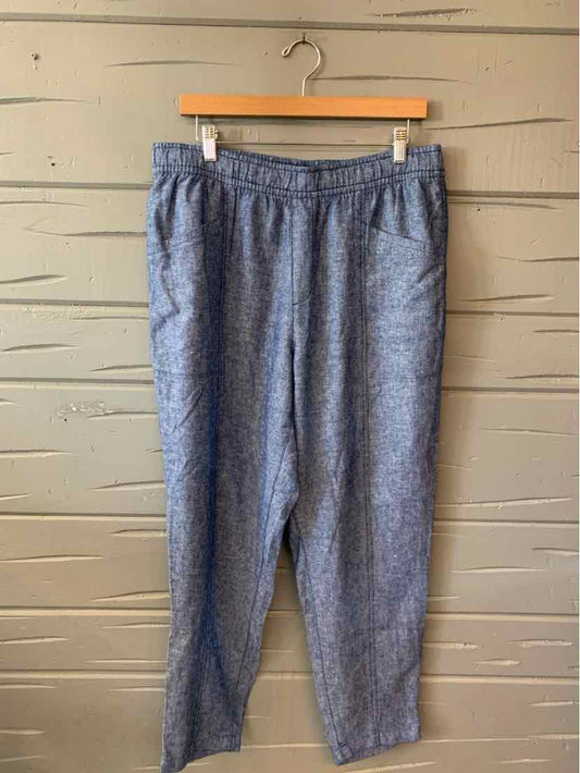 Blue chambray casual pants with elastic waistband and straight legs hanging on wooden hanger.
