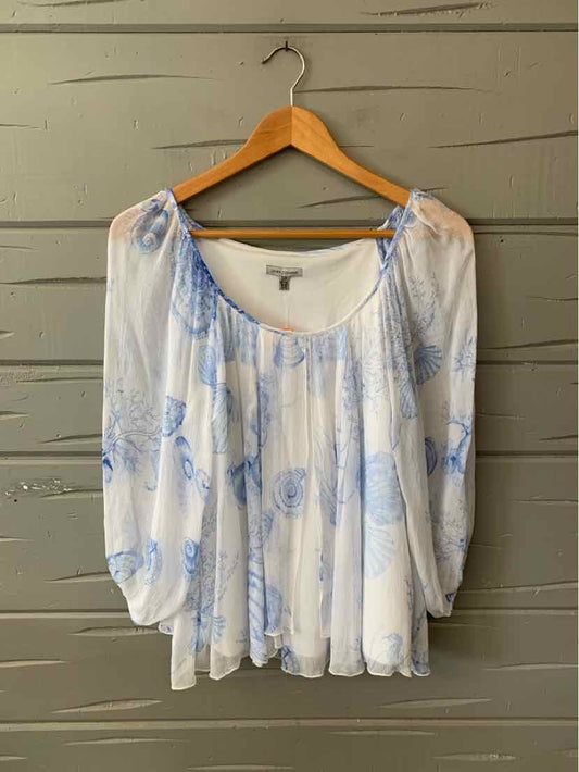 White sheer blouse with blue floral shell print, loose fit, gathered neckline, and long puff sleeves.