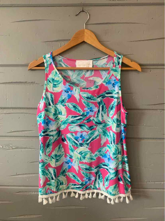 Sleeveless tropical print top in pink, teal, and green with white tassel trim at hem.