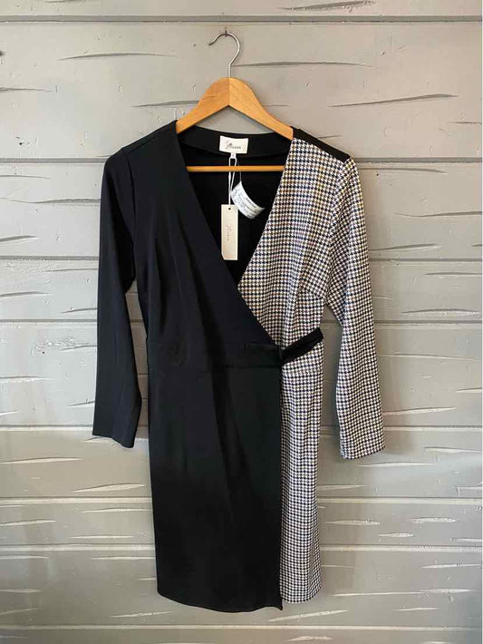 Black and houndstooth pattern wrap dress with long sleeves and waist tie in size small.