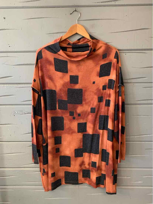 Orange abstract-print tunic with black square accents, long sleeves, and a draped cowl neckline.